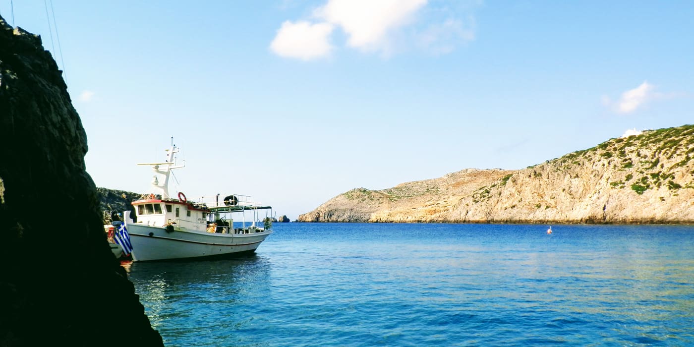 A small ferry in the rocky cove of Bouka on Antikythira